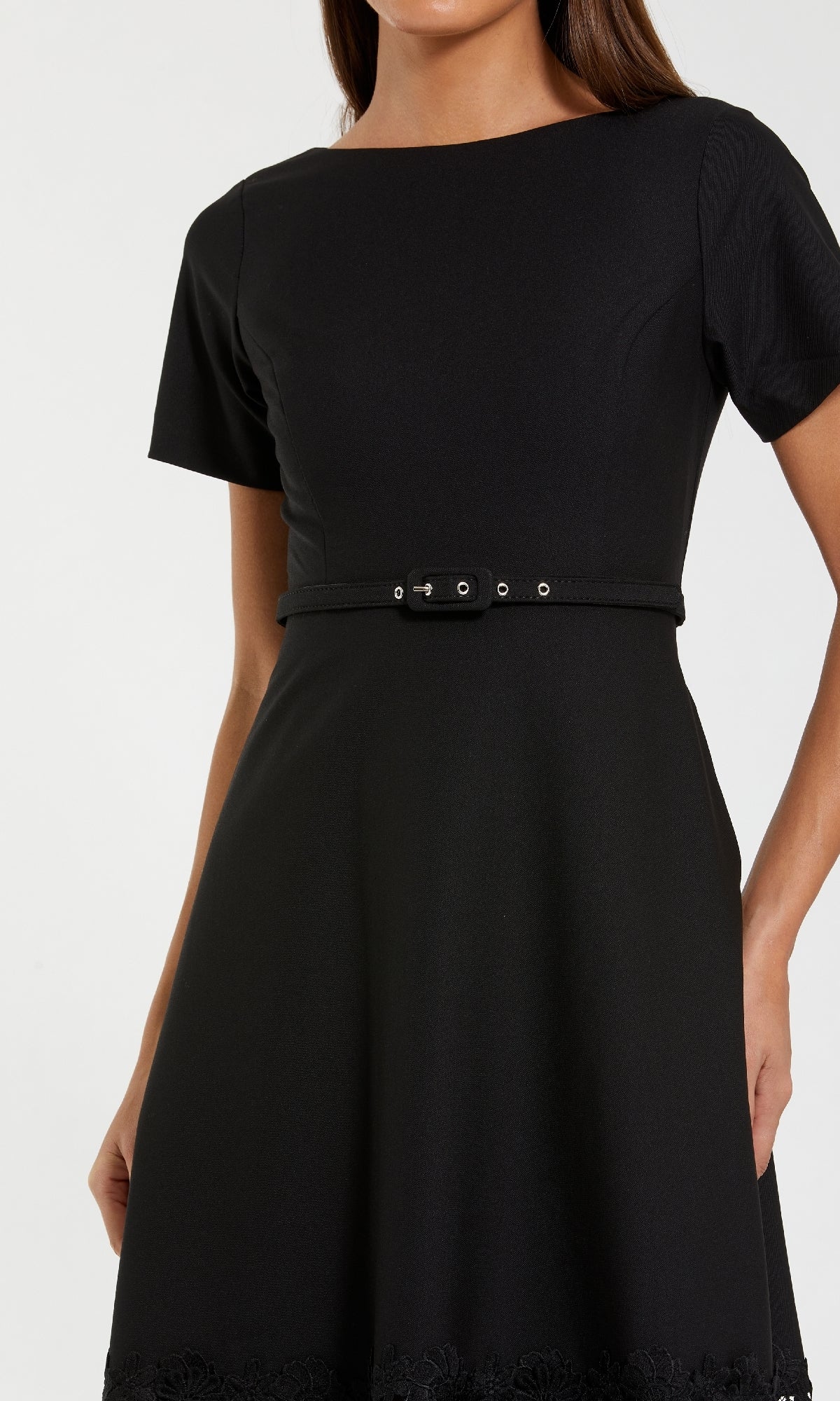 A woman wearing the Mac Duggal 81206 Short Sleeve Midi Cocktail Dress, black with cut-out details and a belted waist, shown from shoulders to mid-thigh.